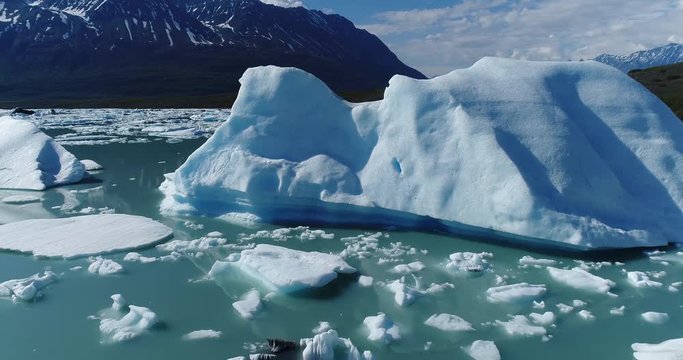 Drone footage of glaciers in water against snowcapped mountains, Alaska, USA