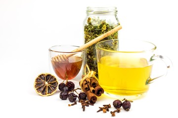 Medicinal herbal tea with honey on white background. Traditional treatment of flu and cold. Alternative medicine. Medicinal herbs.