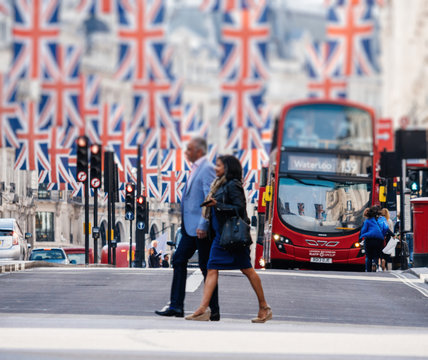 LONDON, UNITED KINGDOM - MAY 18, 2018: Defocused Couple silhouette under Union Jack Flags on Regent Street a day before Royal Wedding. The Royal Wedding between Prince Harry and Meghan Markle