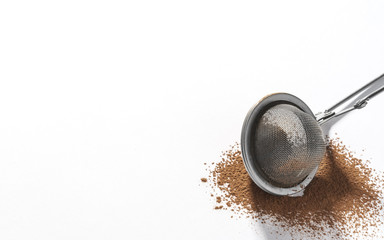 Stainless steel strainer on Chocolate powder isolated on white background with copy space