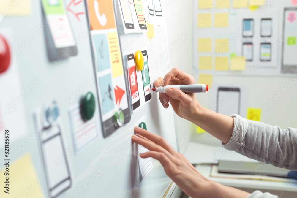 Poster ui website designers are developing a mobile phone application interface. user experience
