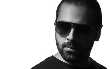 Black and white portrait of middle eastern guy wearing sunglasses isolated on white background