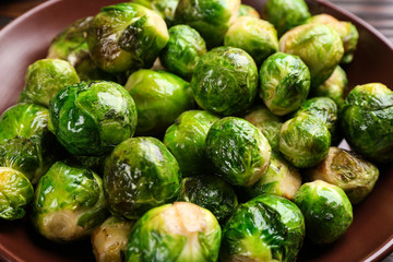 Delicious roasted Brussels sprouts in plate, closeup