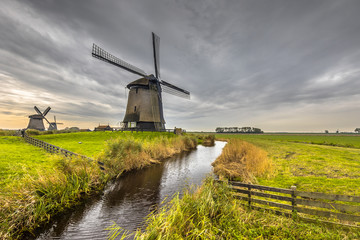 Naklejka premium Traditional wooden windmill canal