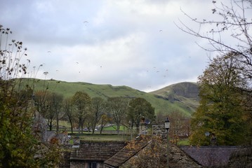 Paragliders over the roof tops of Castleton, Peak District, England, UK from Mam Tor