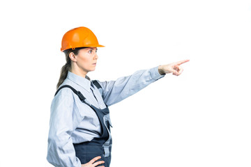 Female engineer builder from the side shows into the distance. Isolated