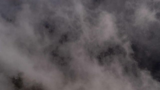 Aerial footage of clouds moving over landscape, Aareschlucht, Berner Oberland, Switzerland