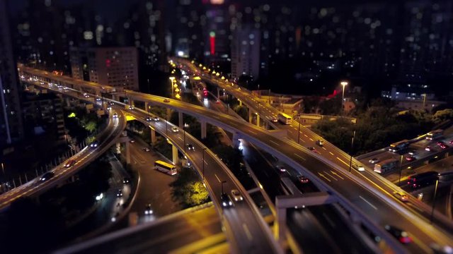 night time illuminated guangzhou traffic road junction aerial panorama tilt-shift 4k china