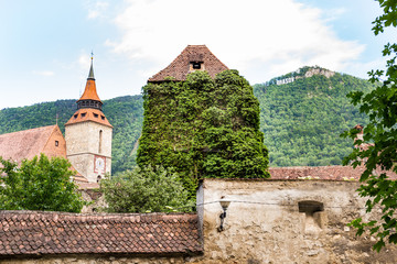 Black Church with the Carpathian Mountains in a spring day, Transylvania, Romania. View of medieval architecture in downtown Brasov.