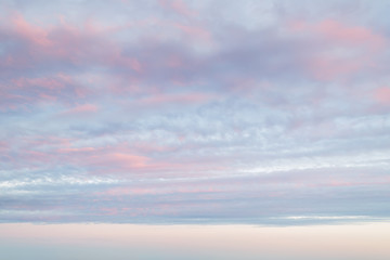 Idyllic vanilla sky of pastel pink and blue colors. Evening sky and clouds as tranquil background. Sweet candy heaven.