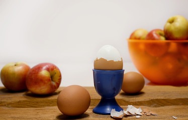 composition of eggs and apples on wood