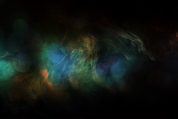 Colored smoke over black studio background