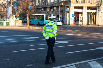 Police agent, Romanian Traffic Police (Politia Rutiera) directing traffic during the morning rush...