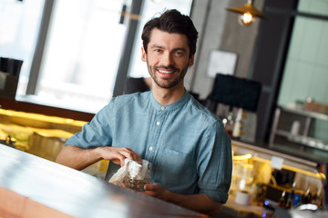 Professional Occupation. Bartender standing at counter wiping glass smiling excited