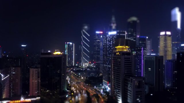 nigh time illuminated guangzhou downtown traffic road aerial panorama tilt-shift 4k china