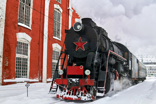 Steam Locomotive Passing Through Train Station In Winter