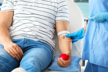 Man donating blood in hospital