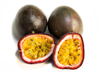 Passion fruit ( Passiflora edulis).3 fruits. The fruit is cut in two halves. Isolated on a white background