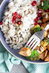 Curry chicken with rice, mushroom and broccoli decorated with pomegranate seeds. Healthy food. Asian cuisine.