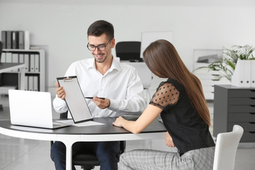 Bank manager working with woman in office