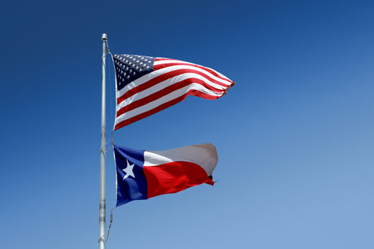 The flags of the United States and of the State of Texas on one flag-pole.