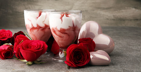Strawberry dessert or ice cream in glasses and rose, decorated with hearts. Valentines Day background