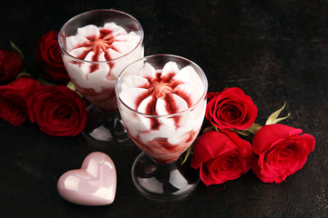 Strawberry dessert or ice cream in glasses and rose, decorated with hearts. Valentines Day background