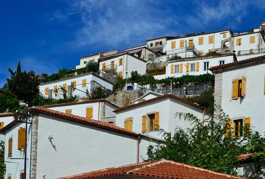 White houses with yellow shutters, Vuno, Albania.