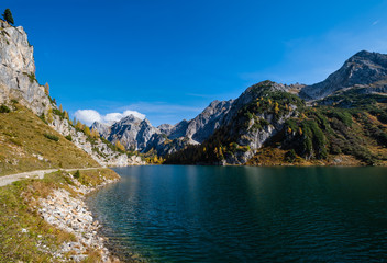 Obraz premium Sunny autumn alpine Tappenkarsee lake and rocky mountains above, Kleinarl, Land Salzburg, Austria.