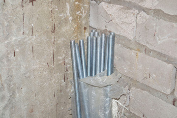 close-up of threaded stud package in stock in corner of warehouse