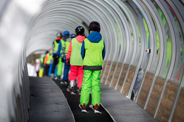 Chidren in ski school on conveyor belt