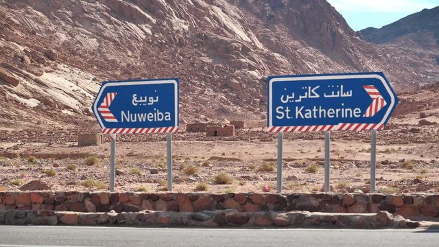 Ancient buildings and road signs near Saint Catherines Monastery in Sinai peninsula, Egypt