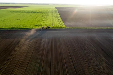 Deurstickers Aerial image of tractor working in field © Budimir Jevtic