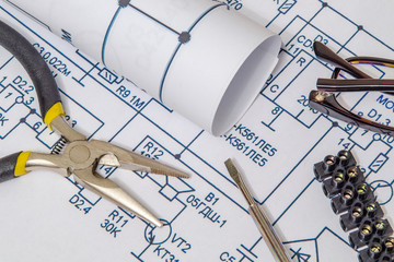 Electrical diagrams and metal pincers building a house concept for engineering projects