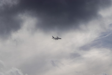 Fototapeta na wymiar Airplane in the cloudy sky - Passenger Airliner aircraft, London, England