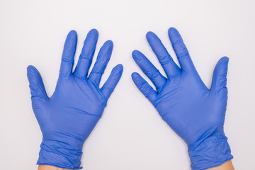 Human hands wearing blue surgical latex nitrile gloves for doctor and nurse protection during...