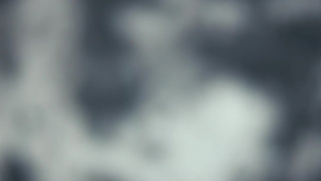 Blurred background of Security contractor walking past camera with an AR15 rifle