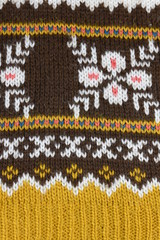close up knitted warm winter product. skandinavian pattern, brown, white, ocher