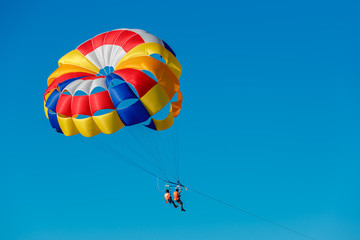 Parasailing, skydiving high in the blue sky