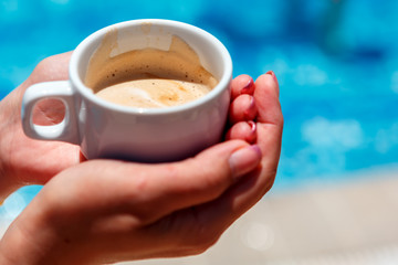 A Cup of coffee in your hands on a bright Sunny day
