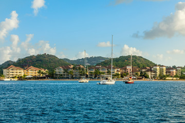 Fototapeta na wymiar Offshore view of Rodney bay with yachts anchored in the lagoon and rich resorts in the background, Saint Lucia, Caribbean sea