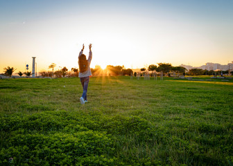 young woman jumping in the field