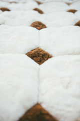 White furry plush blanket with brown diamonds and squares