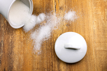 Top view photo of sugar on the wooden background