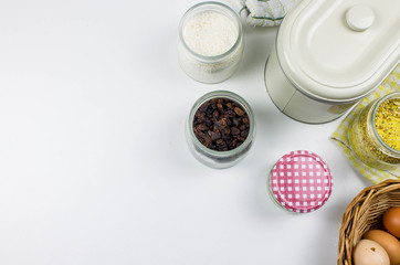Preparation of the dough. Ingredients for the dough - flour, jar, eggs and various tools. On white background. Free space for text . Top view. Still life. Flat lay