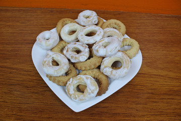 Sweet donuts and cookies on a white plate