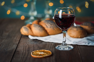 Shabbat Shalom. Challah bread, shabbat wine and candles on the festive background