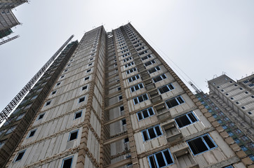 Fototapeta premium Construction of a multistoriyed condominium building, close up. View from bottom. 