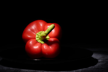 red sweet pepper on a black background