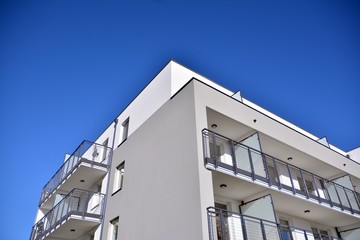 Obraz premium Contemporary residential building exterior in the daylight. Modern and new apartment building. 